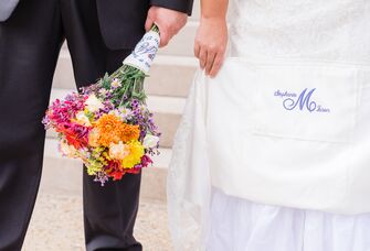 Bride with monogrammed wedding dress