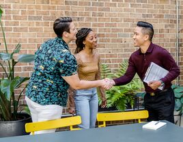 Couple shaking hands with wedding planner