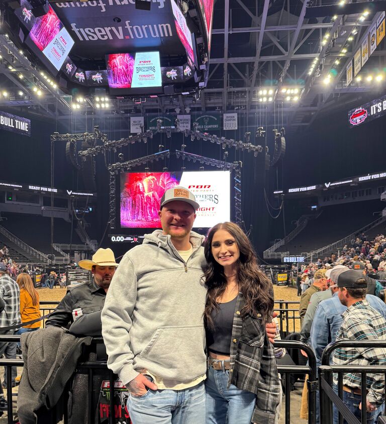 Lukas and Katie at their first PBR rodeo together in Milwaukee. Katie won front row and shark cage tickets from a Busch Light contest.