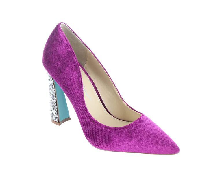 Purple shoe with a pointed toe and a blue bedazzled heel. 