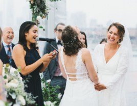 Couple laughing together while officiant is doing wedding reading