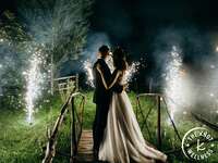 Bride and groom watching fireworks at end of wedding day
