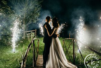 Bride and groom watching fireworks at end of wedding day