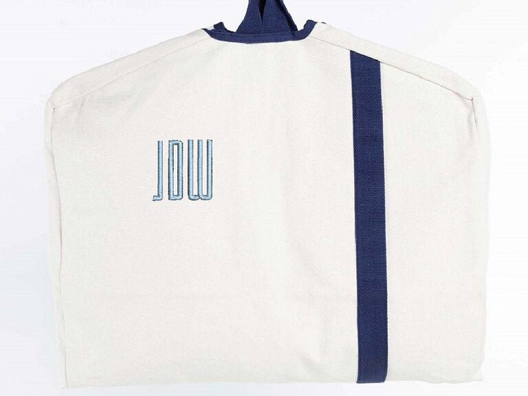 White canvas bag with blue vertical stripe and monogram
