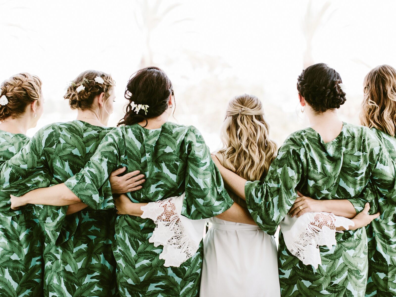 Bride with bridesmaids after getting hair done