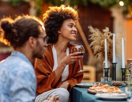 Couple dining outdoors with outdoor wedding registry items