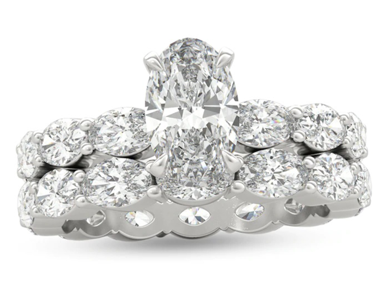 Center oval diamond on silver double band with smaller oval diamonds