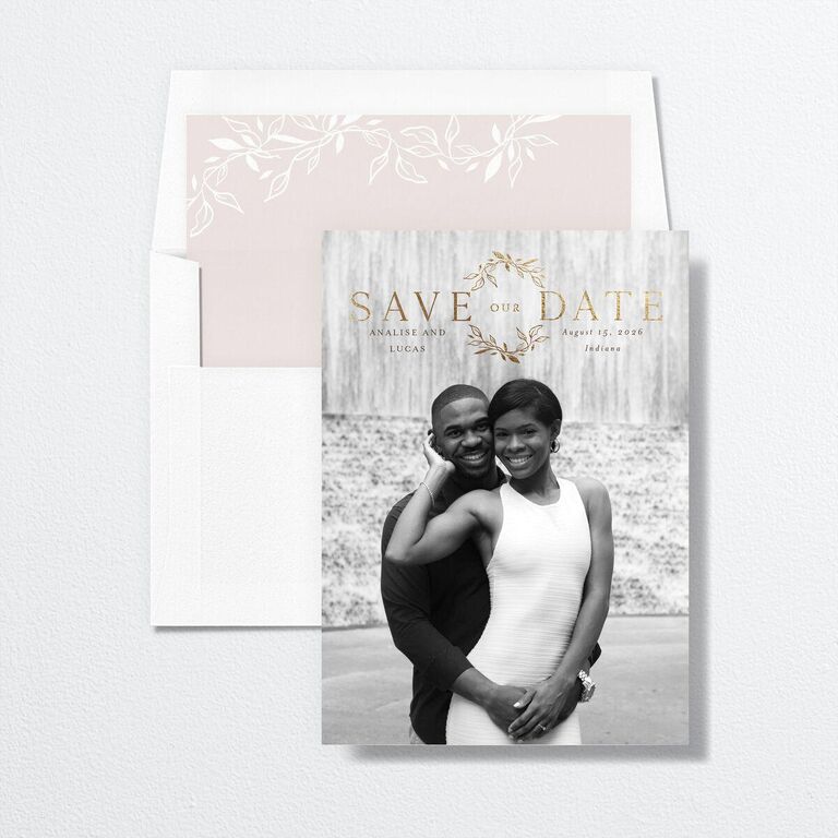 Black and white save-the-date with gold foil monogram and wreath