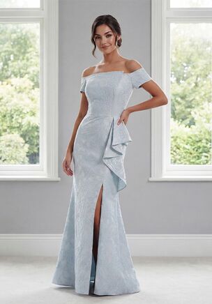 Sophisticated and fashion-forward, this Gabrielle Jacquard fit-and-flare gown is a stunning choice for the Mother of the Bride. The off-the-shoulder short sleeves and portrait-angled neckline create a flattering and modern silhouette, while the natural waistline flows into a skirt with a unique front slit and cascading ruffle for graceful movement. Elegant, contemporary, and full of charm, this gown combines timeless style with fresh, eye-catching details.