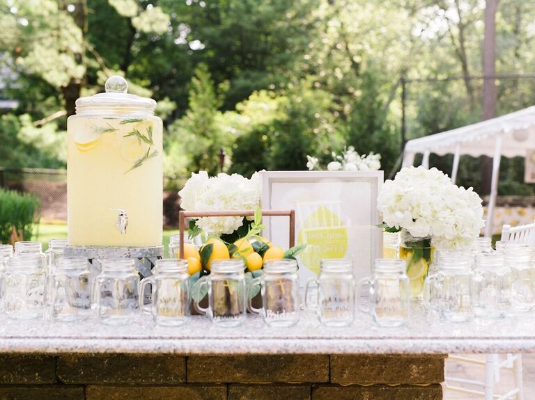 lemonade drink dispenser with mason jars at outdoor wedding