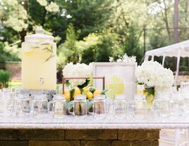 lemonade drink dispenser with mason jars at outdoor wedding