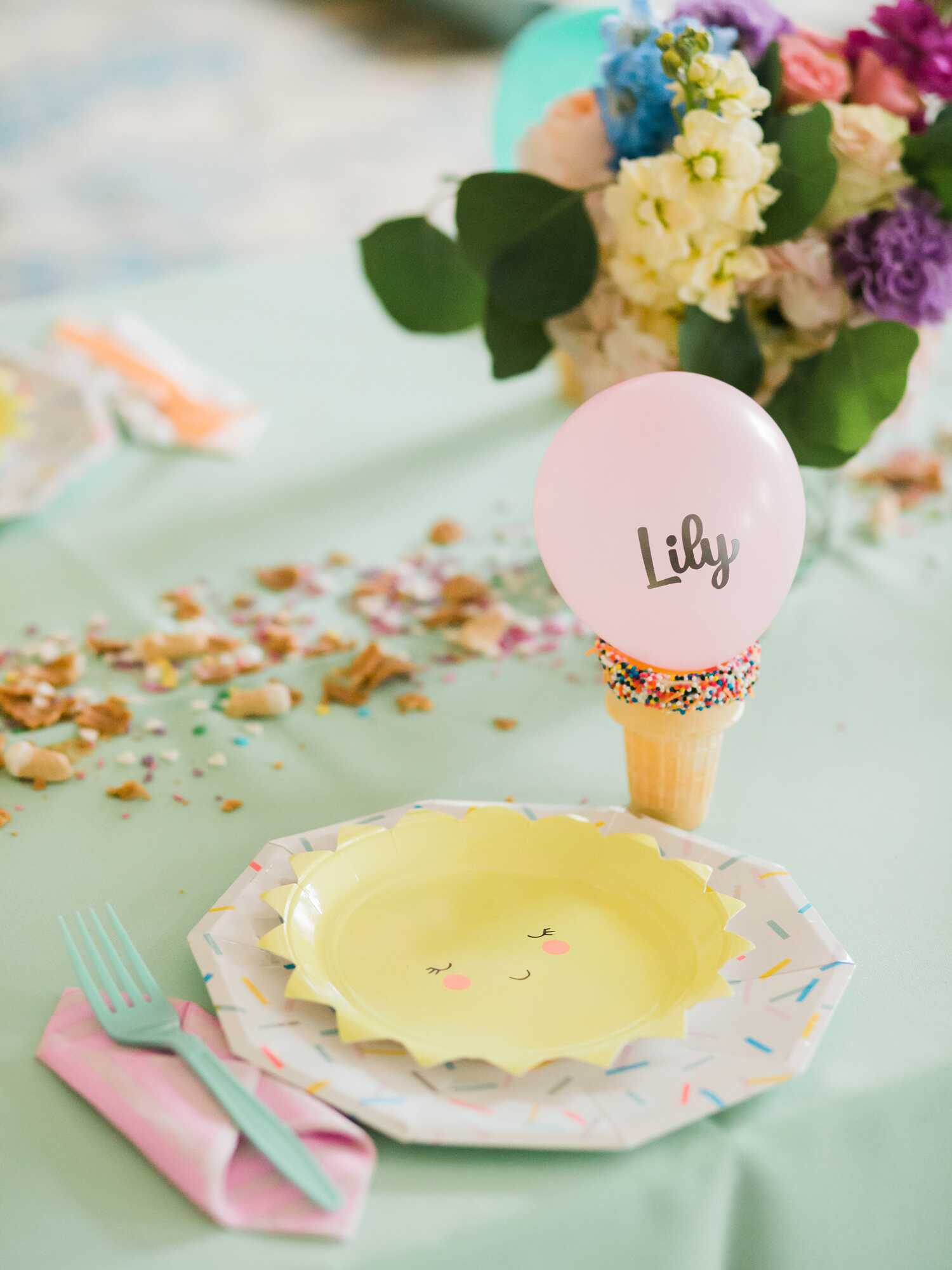 Small pink balloon name card attached to an ice cream cone
