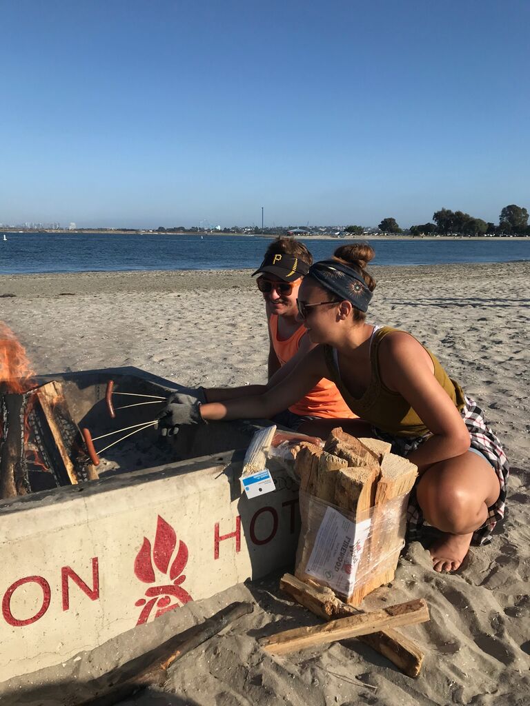 Roasting some hot dogs by the bay.