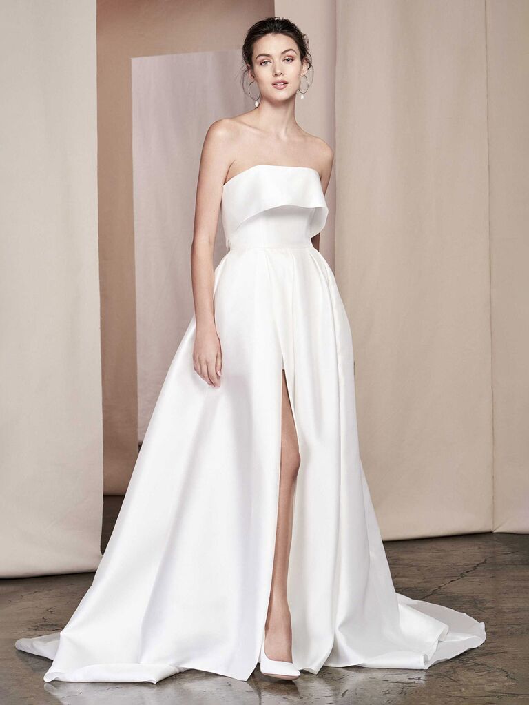 justin alexander plain white silk strapless wedding dress with folded trimmed neckline pockets and pleated ball gown skirt with slit