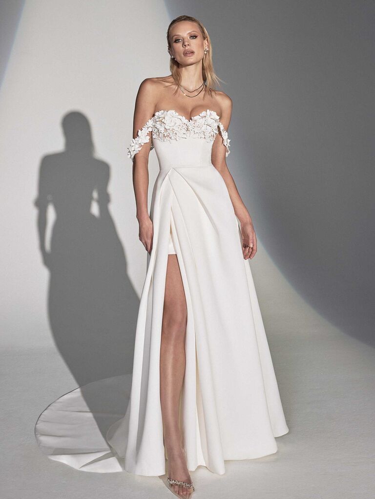 Model wears a white strapless dress, best floral wedding dresses 2023-2024. 