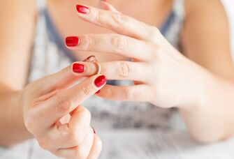 Woman taking off her wedding band