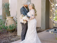 Bride and groom hugging each other in western country attire