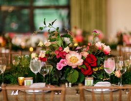 classic wedding centerpiece with white flowers, greenery and white taper candles