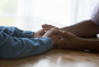 Couple holding hands on a table