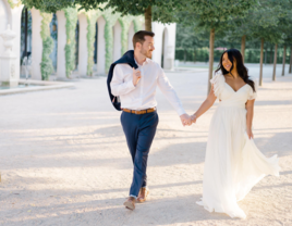 Couple holding hands and smiling for their engagement photos