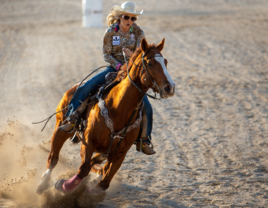 cowgirl riding horse at rodeo