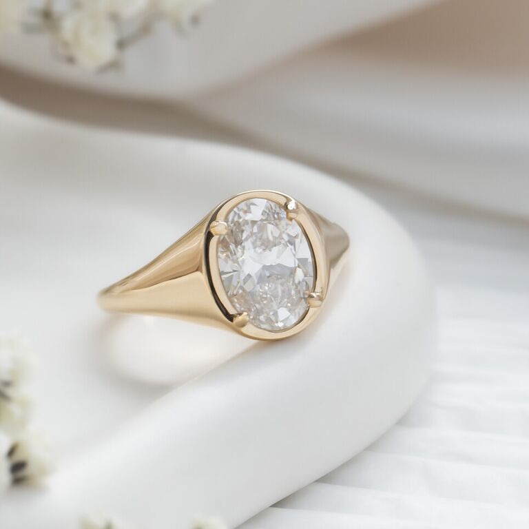 Oval signet solitaire diamond engagement ring 