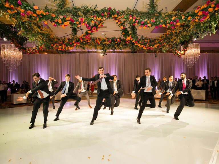 Groomsmen performing a choreographed dance at a wedding reception.