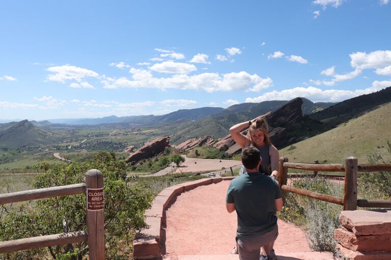 Tim proposed on a trip to Denver, Colorado to visit Cameron for her birthday. Lexie was under the impression that Tim was disc golfing with his friends, and she was going sight seeing with her friends. When they got to the top of the overlook at Red Rocks, Tim was there waiting with his friends and got down on one knee. <3 Check out the photos tab for more!
