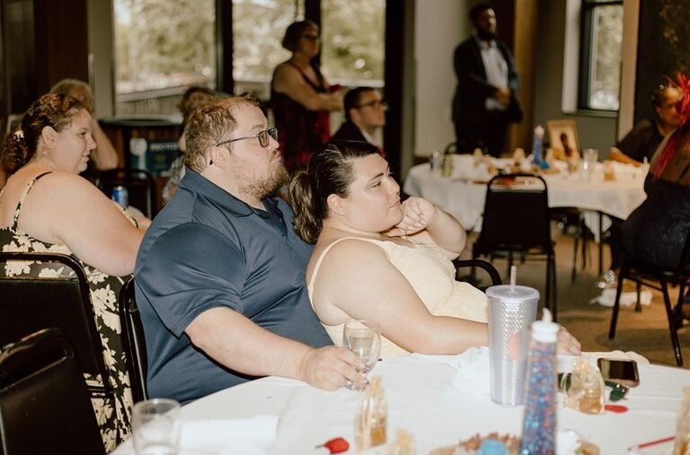 Just in case you weren't sure whether we liked each other—here's a picture of us being cute while listening to wedding speeches. :)