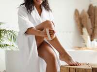 Woman exoliating legs to get rid of razor bumps