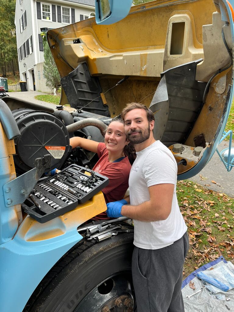 Living in the engine of the bus to avoid paying a mechanic our net worth (it all worked out)