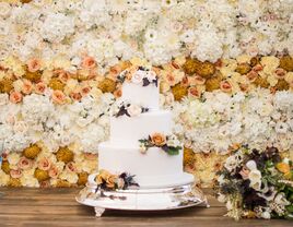 three-tier fall wedding cake decorated with hand-piped polka dots and fresh flowers
