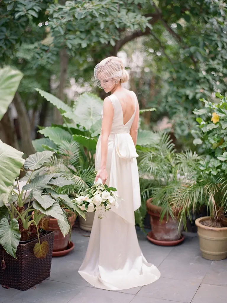 Bride wearing birdcage wedding veil 