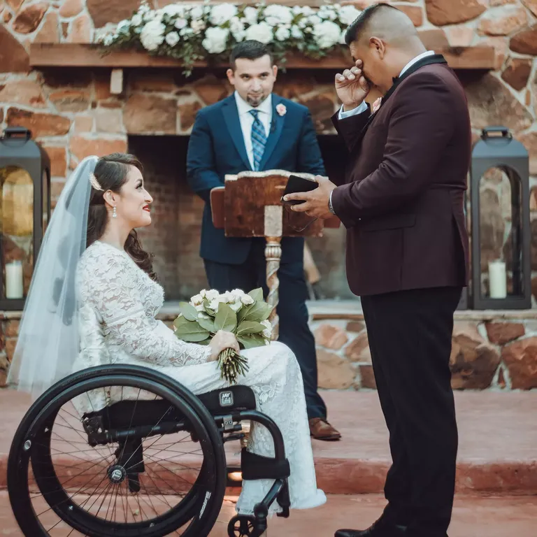 Groom crying while exchanging vows with bride
