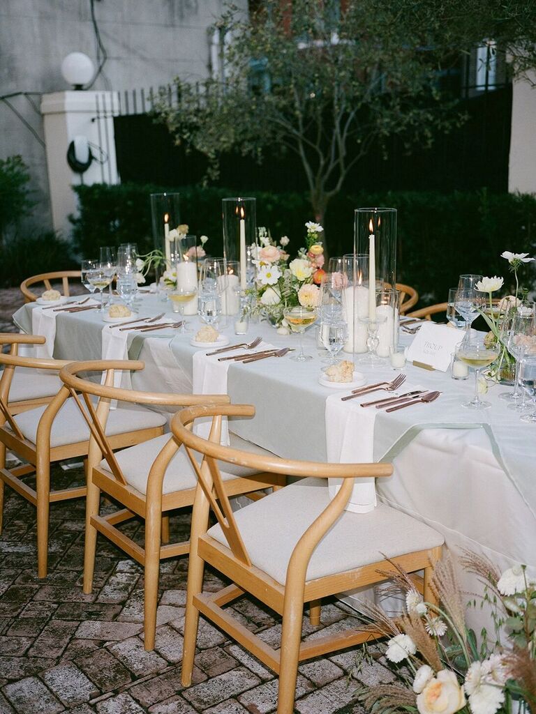 Different sized floral centerpieces and candles