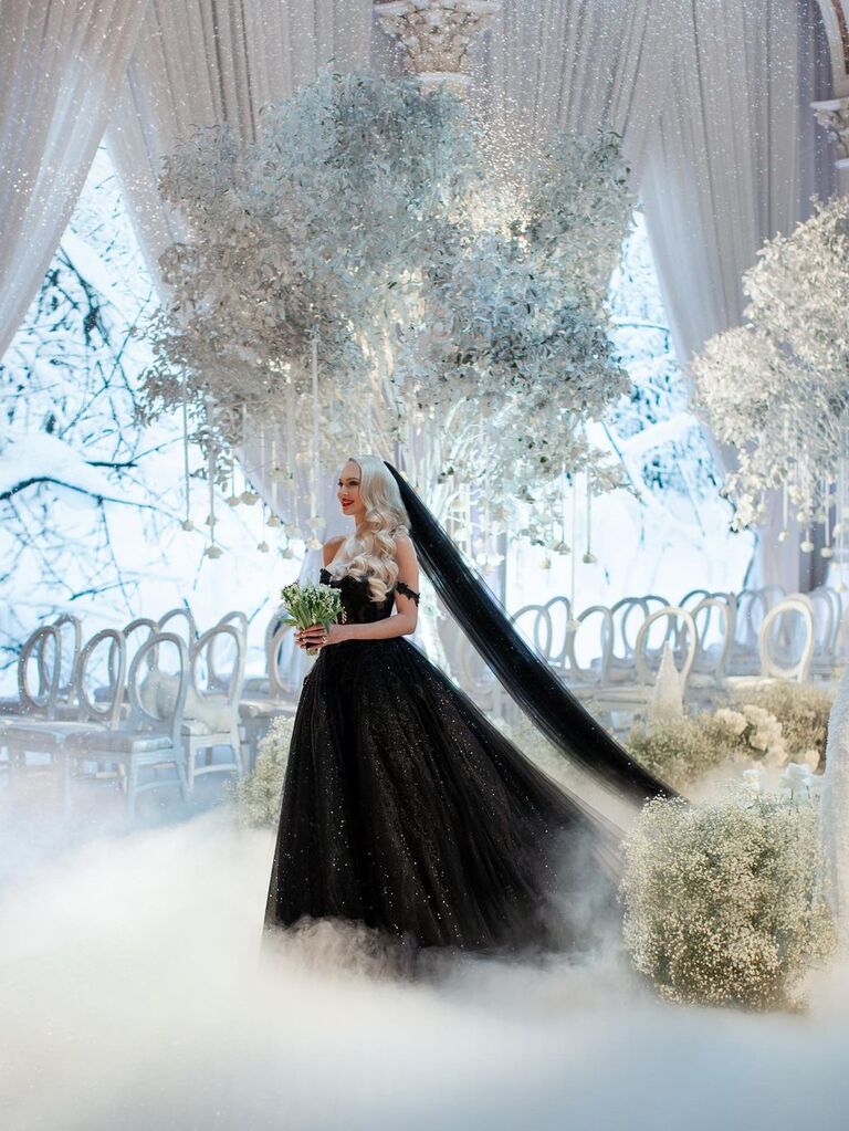 Christine Quinn wears a black wedding veil. 