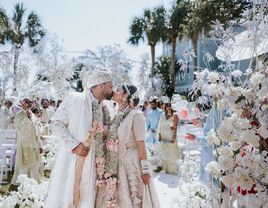 Happy couple kissing at the bottom of the aisle