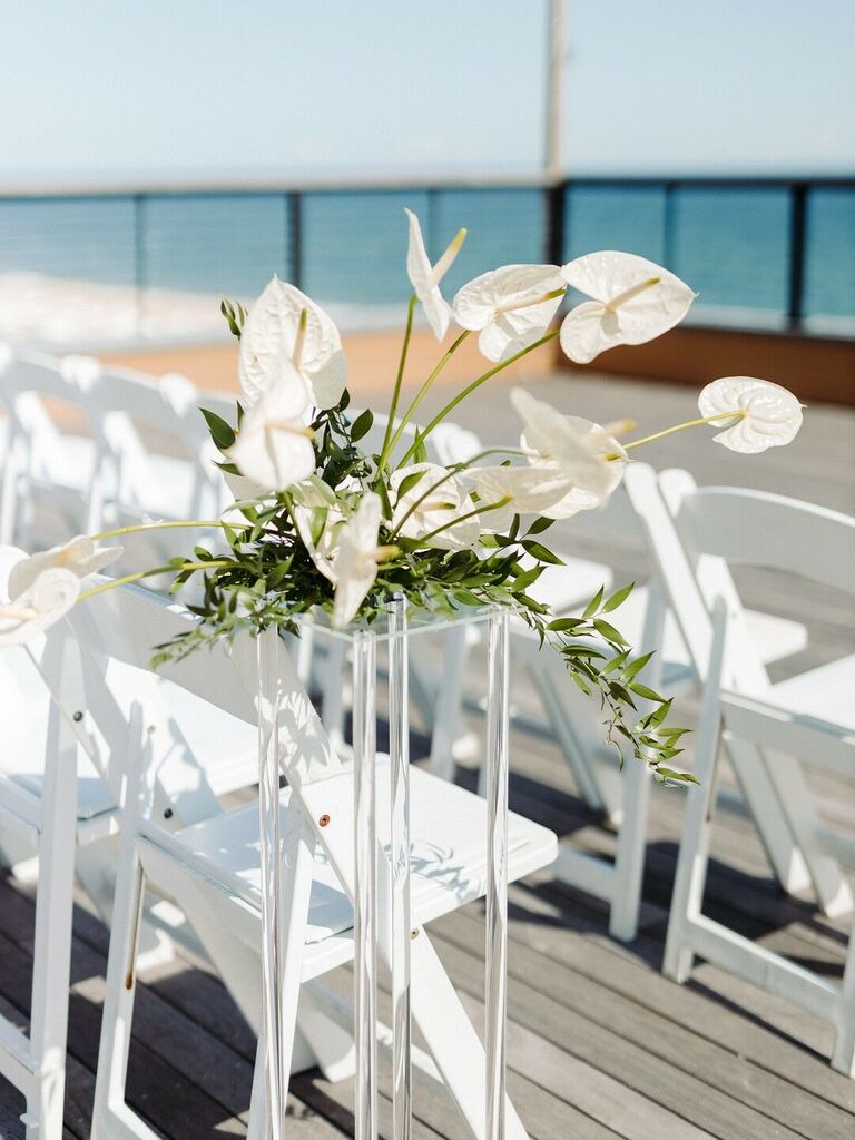 modern wedding aisle marker with white anthuriums displayed on clear acrylic base