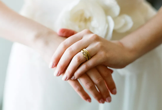 Woman wearing low-set engagement ring 