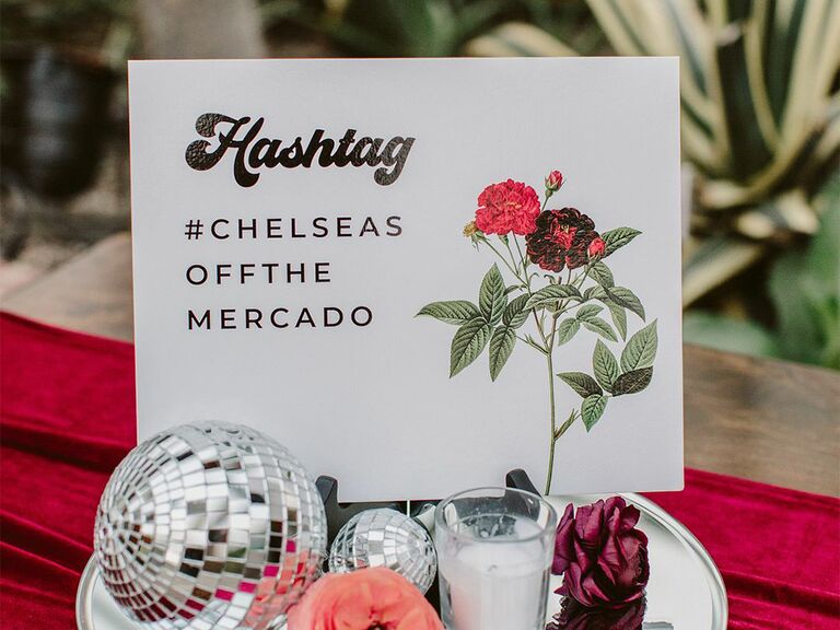 Retro wedding hashtag sign that says "#ChelseasOffTheMercado"