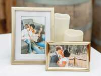 Couples engagement photos in gold frame on table
