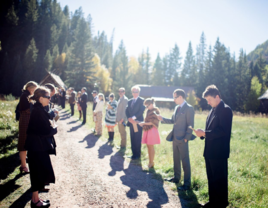 Family standing in receiving line outside before wedding ceremony 