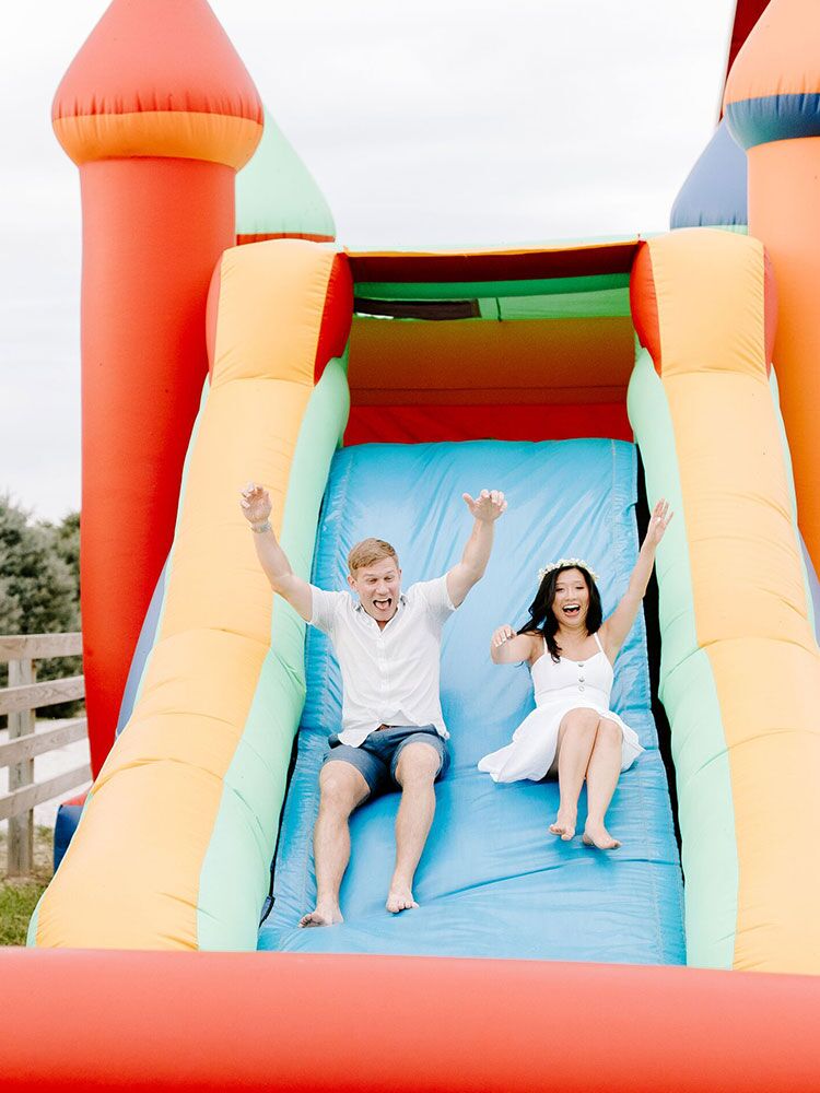 couple on inflatable slide
