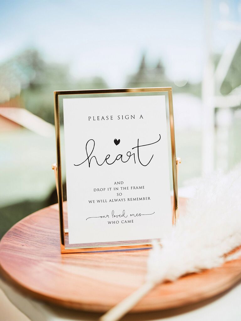 'Please sign for a heart' in minimalist type in gold frame