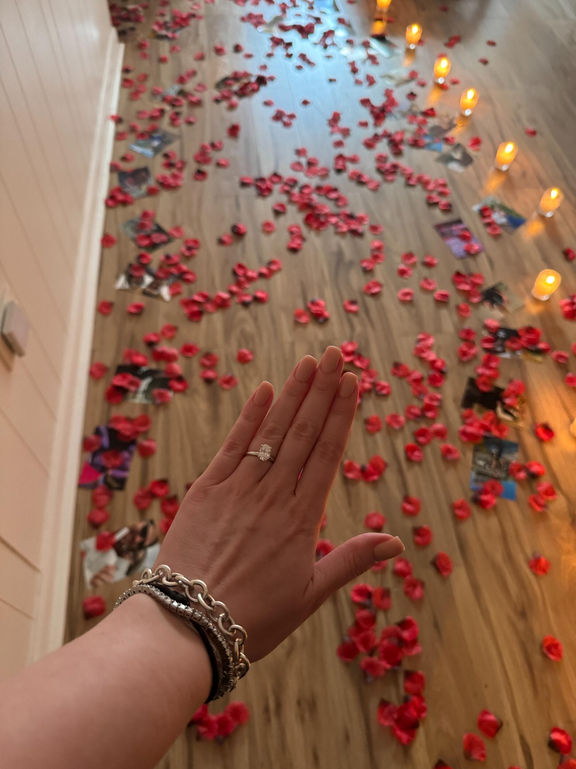 Daniel proposed to Elizabeth when she got home from her nail appointment. He had pictures, candles, and 2000 rose petals all over their apartment. He asked her to marry him and she said yes! 