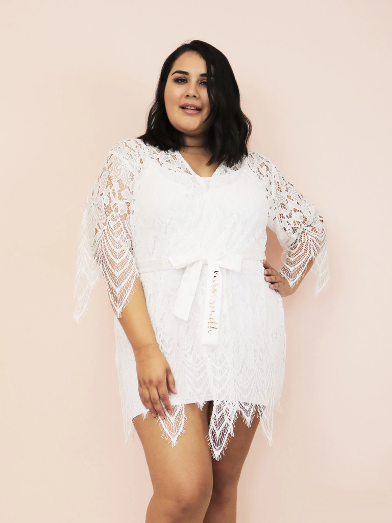 A model shows off her Short Lace Wedding Robe, with its stunning diamond-pattern lace sleeves.