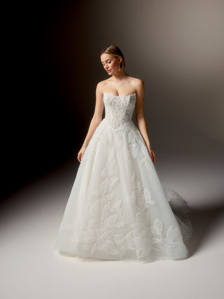 Strapless Justin Alexander wedding dress with curved waist and floral embroidery