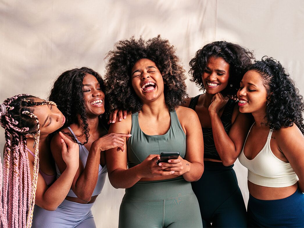 Friends laughing at bachelorette party group chat