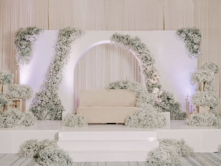 All-White Reception Stage Adorned with Baby's Breath