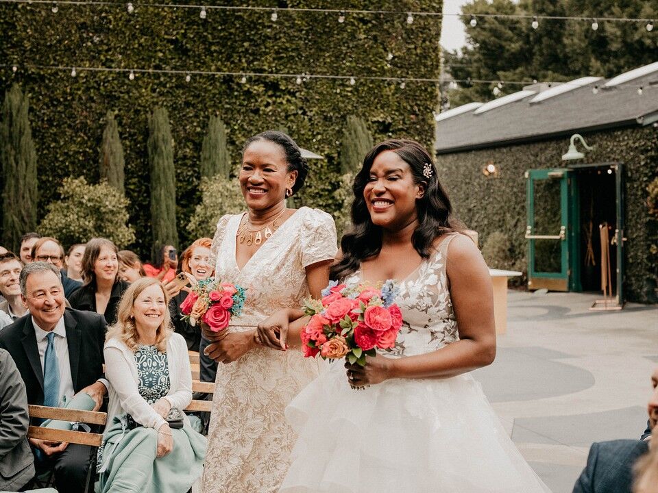 Bride and mother of the bride walking down the aisle